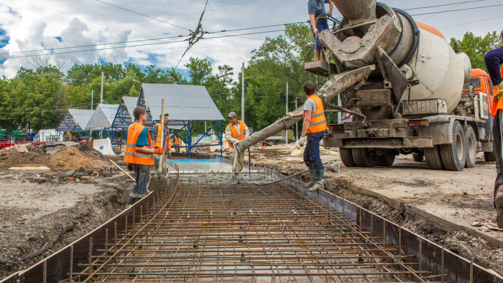 Concrete works for road construction with many workers and mixer timelapse 