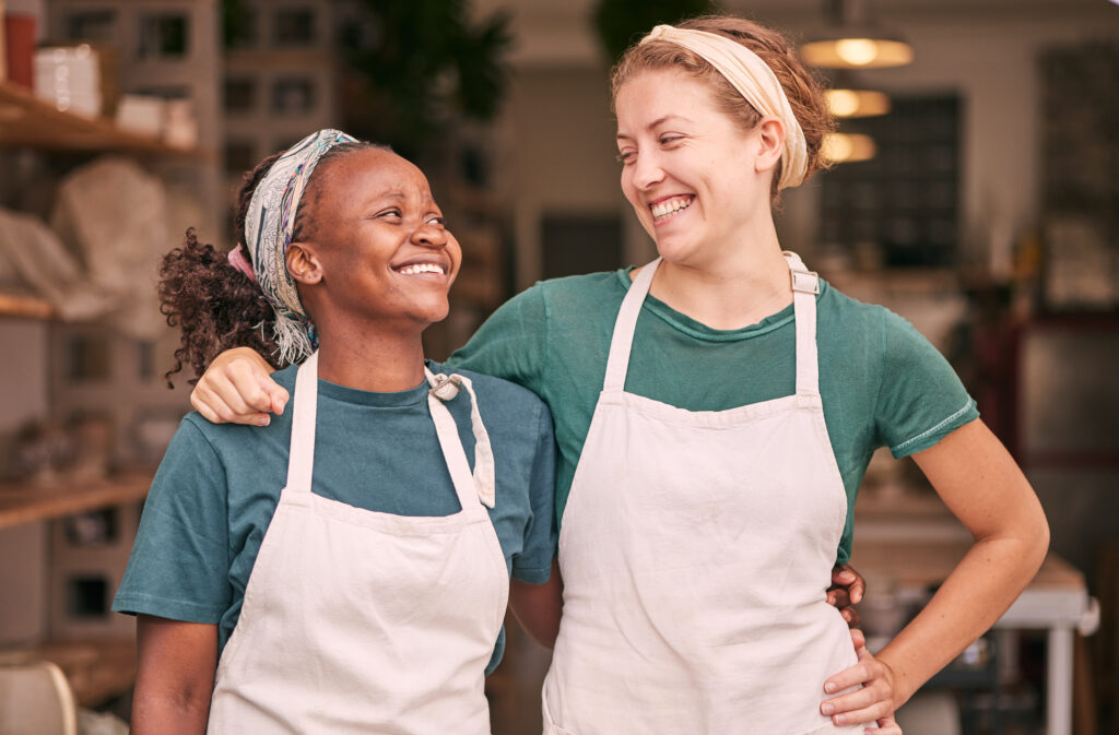 Creative workshop, teamwork and women in small business, artistic startup and pottery studio. Collaboration, success and happy female friends with ceramic production, clay sculpture and artwork store Yuri Arcurs peopleimages.com